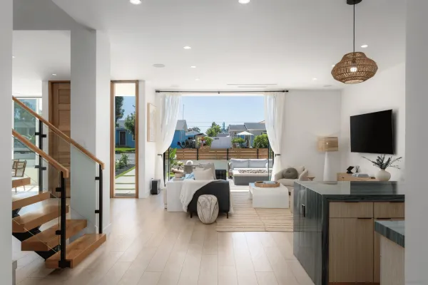 a living room with furniture a flat screen tv and a large window