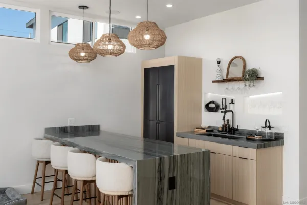 a bedroom with a bed a table and potted plant