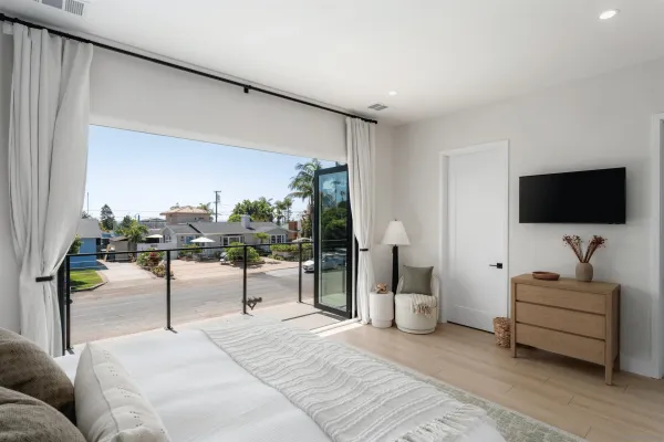 a large bedroom with a bed and glass window