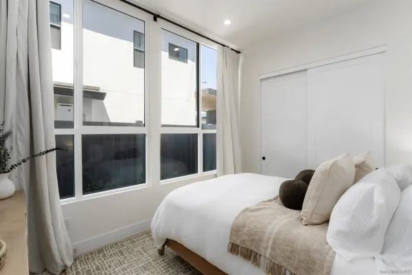 a bedroom with a bed couch and a window