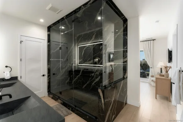 a bathroom with a mirror and a shower