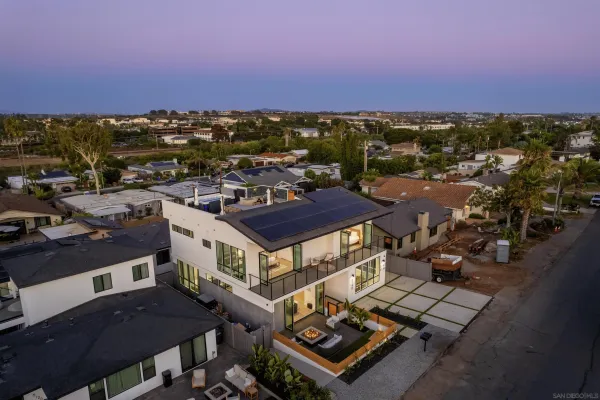 an aerial view of a houses with a city street