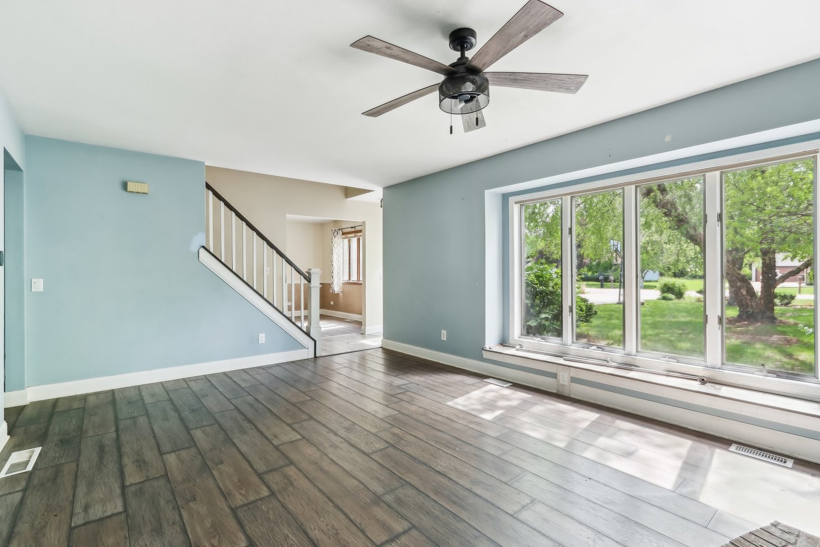 1888 Irene Road Sandwich, IL 60548 - Photo 3 of 35 a view of an empty room with wooden floor and a window