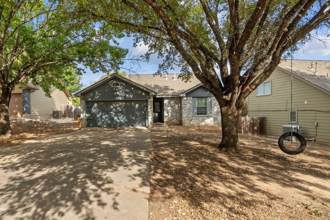 4904 Gnarled Oak Cove Austin, TX 78744 - Photo 1 of 38 a front view of a house with garden