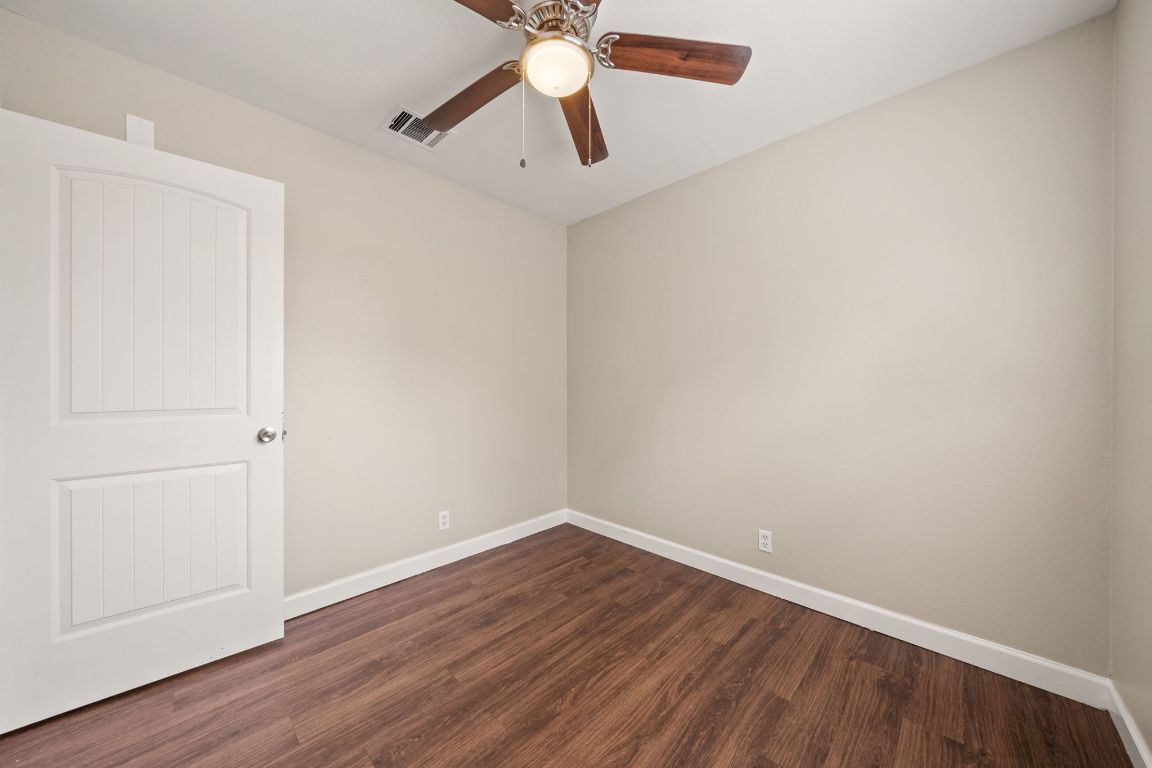 4904 Gnarled Oak Cove Austin, TX 78744 - Photo 11 of 38 a view of an empty room with wooden floor