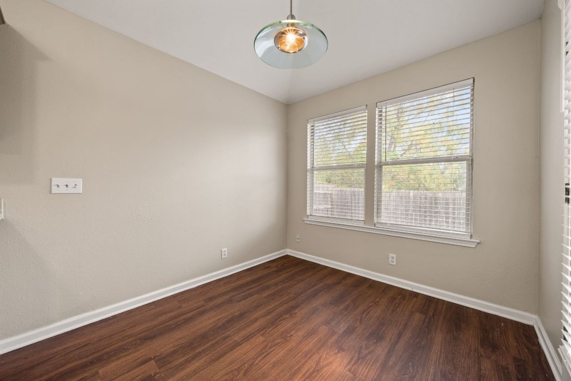 4904 Gnarled Oak Cove Austin, TX 78744 - Photo 16 of 38 an empty room with wooden floor and windows