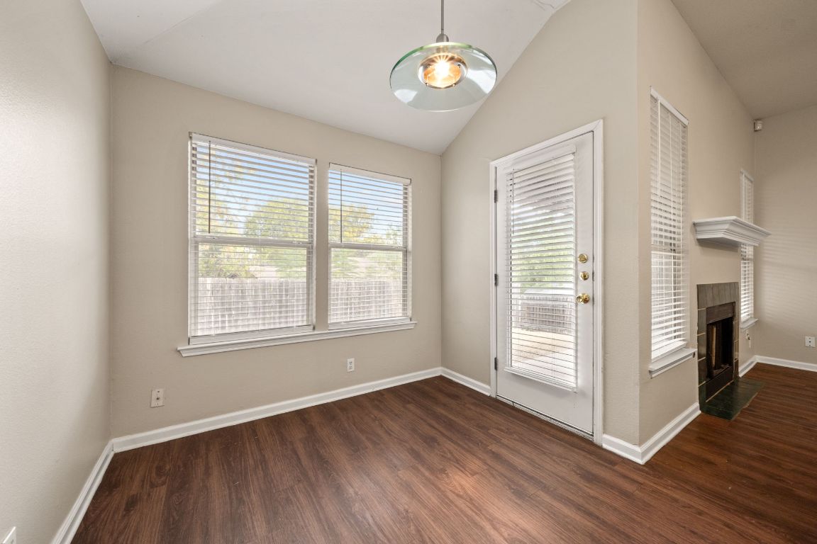 4904 Gnarled Oak Cove Austin, TX 78744 - Photo 19 of 38 an empty room with wooden floor and a large window