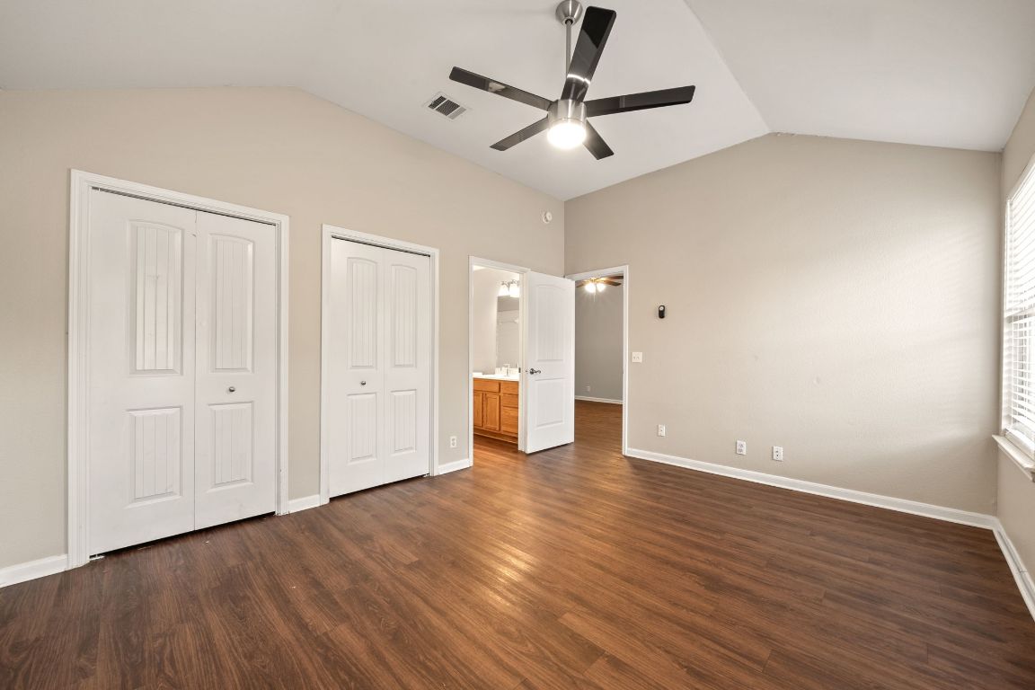 4904 Gnarled Oak Cove Austin, TX 78744 - Photo 28 of 38 an empty room with wooden floor and windows