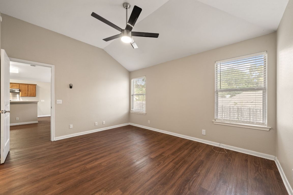 4904 Gnarled Oak Cove Austin, TX 78744 - Photo 29 of 38 an empty room with wooden floor and windows