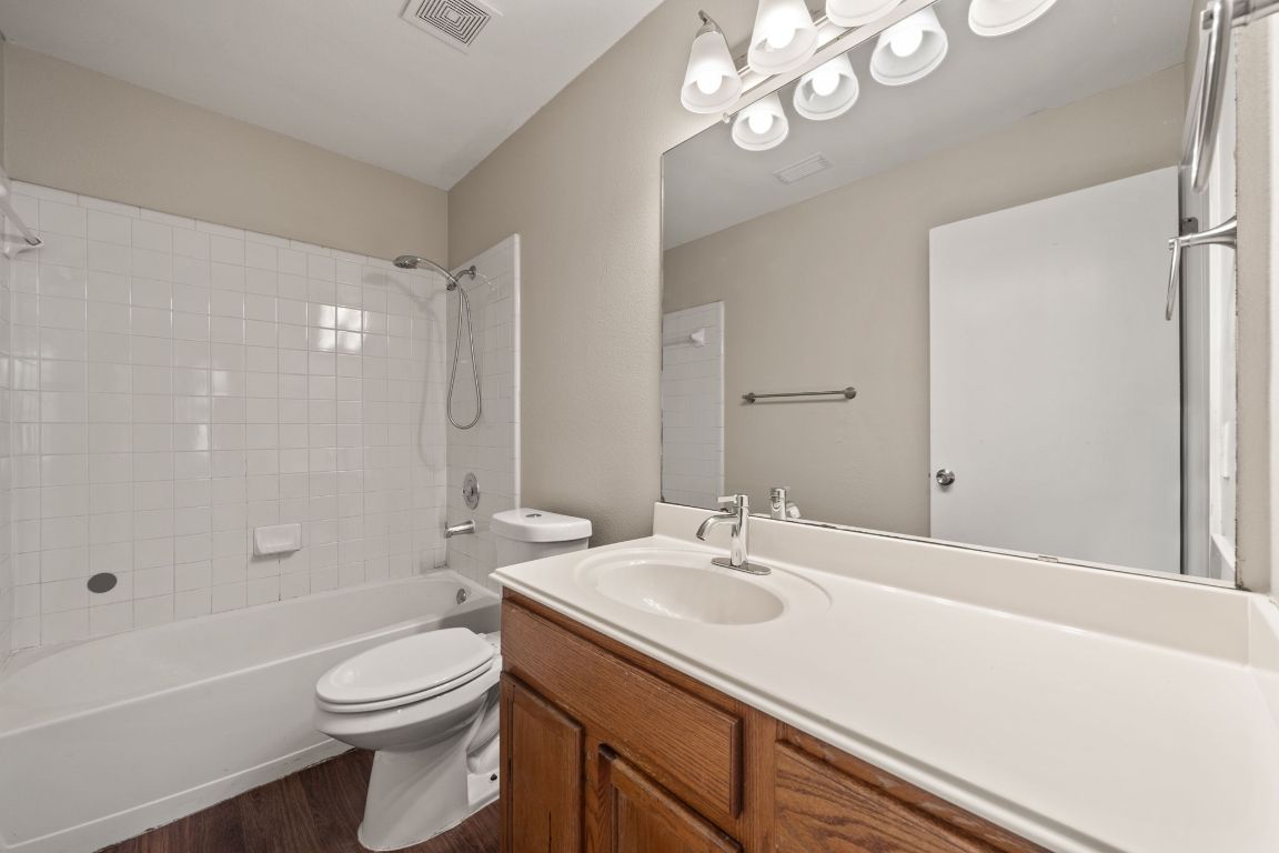 4904 Gnarled Oak Cove Austin, TX 78744 - Photo 30 of 38 a bathroom with a sink a toilet and shower