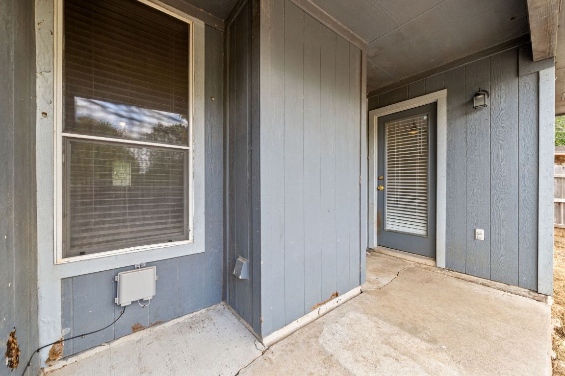 4904 Gnarled Oak Cove Austin, TX 78744 - Photo 33 of 38 a view of an empty room with wooden floor and a window