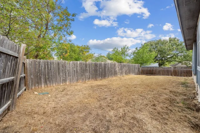 a view of outdoor space with wooden fence
