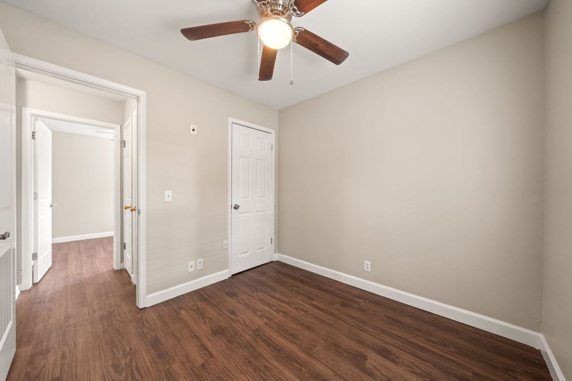 4904 Gnarled Oak Cove Austin, TX 78744 - Photo 7 of 38 a view of an empty room with wooden floor