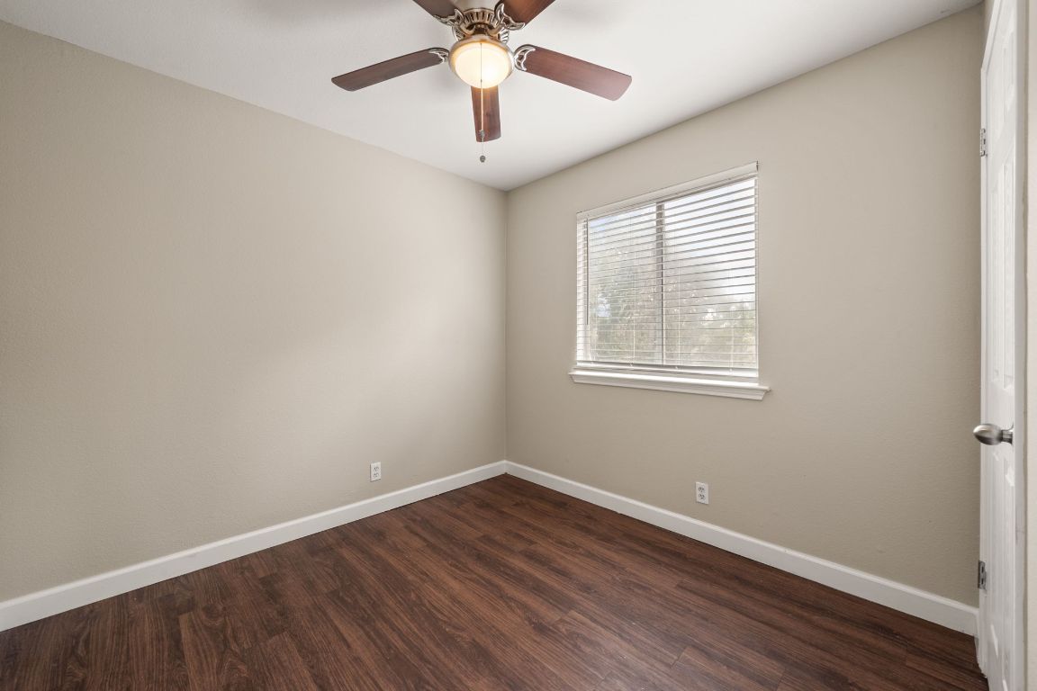 4904 Gnarled Oak Cove Austin, TX 78744 - Photo 8 of 38 wooden floor in an empty room with a window