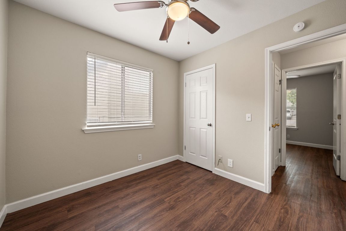 4904 Gnarled Oak Cove Austin, TX 78744 - Photo 9 of 38 a view of empty room with wooden floor and fan