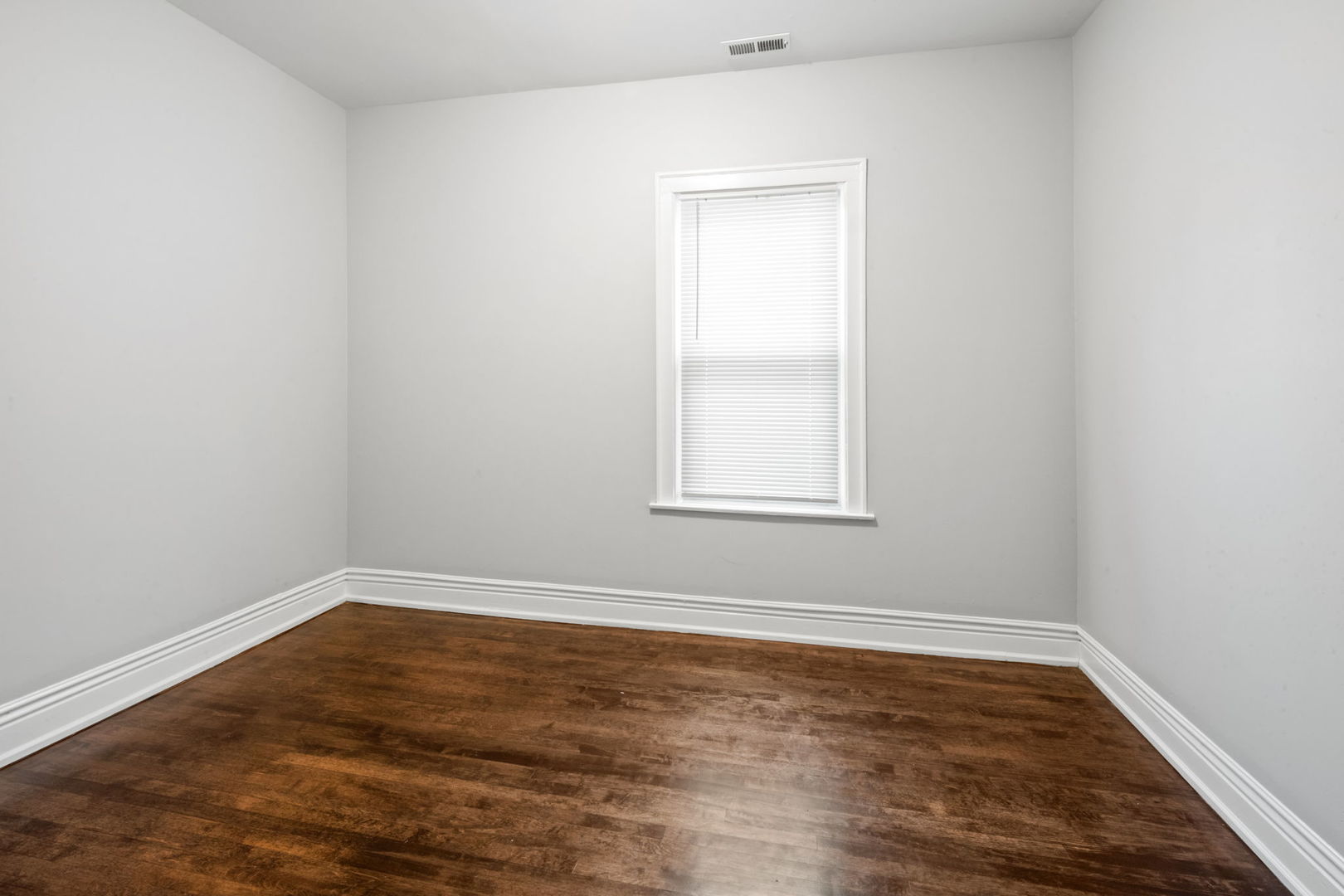 8548 South Exchange Avenue Chicago, IL 60617 - Photo 12 of 32 an empty room with wooden floor and windows