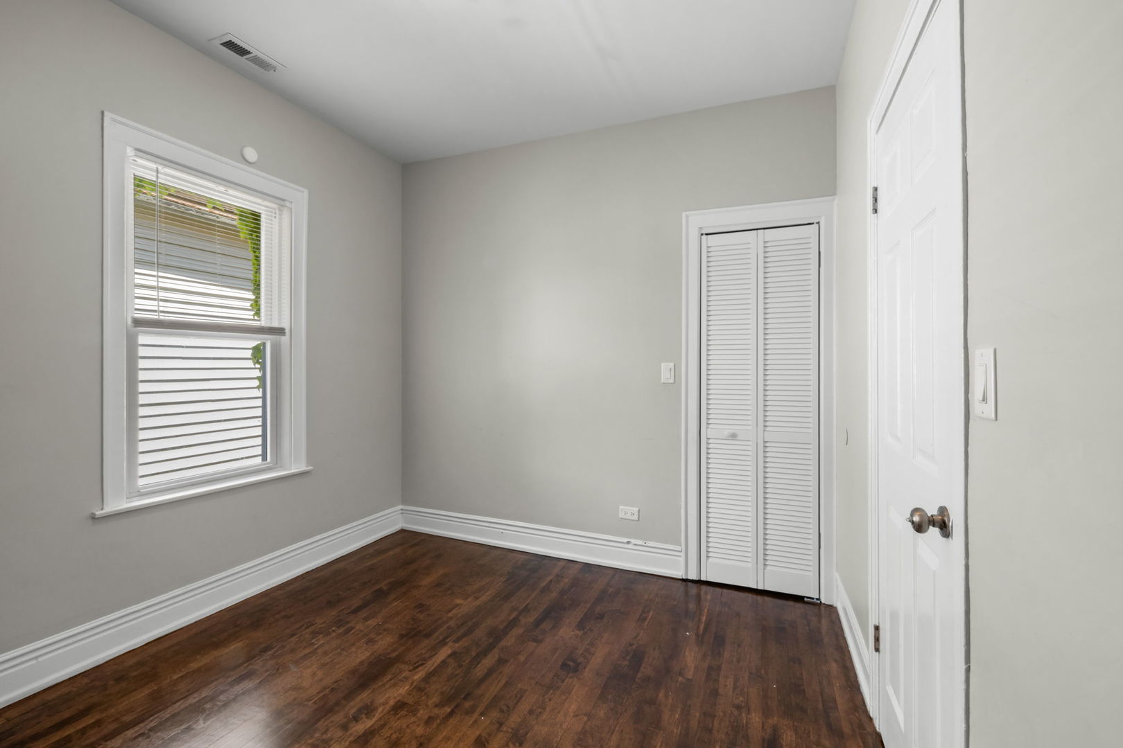 8548 South Exchange Avenue Chicago, IL 60617 - Photo 16 of 32 an empty room with wooden floor and windows