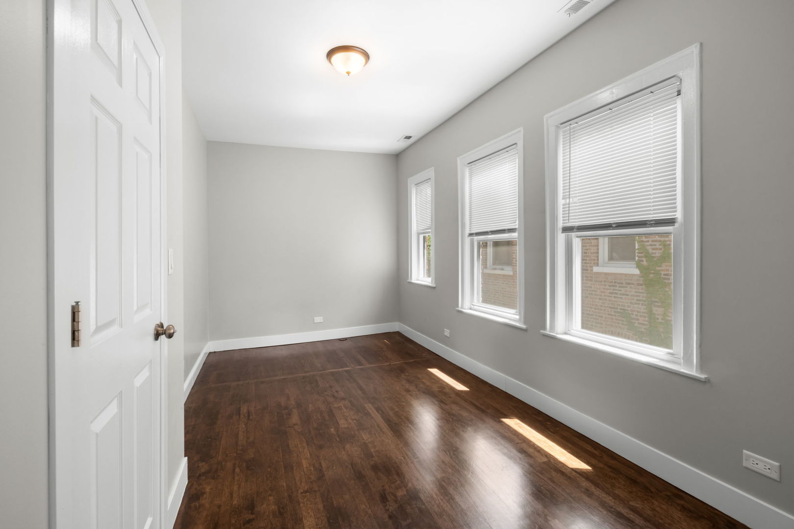 8548 South Exchange Avenue Chicago, IL 60617 - Photo 18 of 32 an empty room with wooden floor and windows