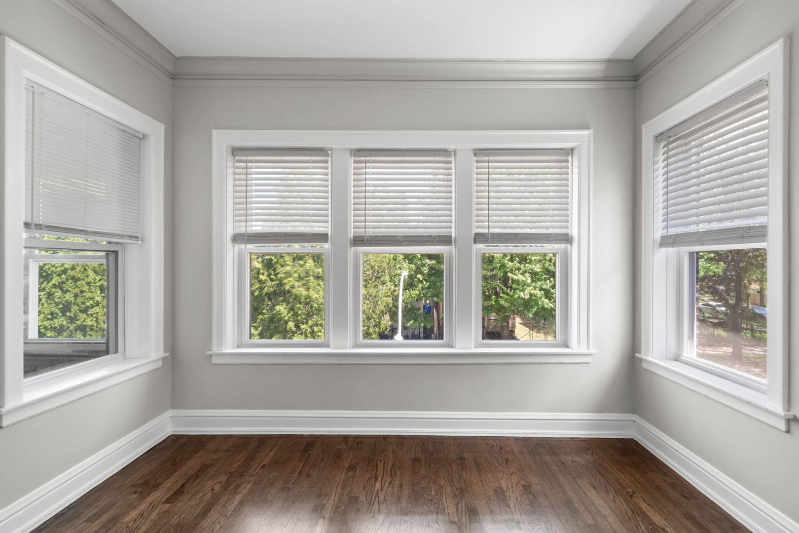 8548 South Exchange Avenue Chicago, IL 60617 - Photo 5 of 32 a view of an empty room with wooden floor and a window