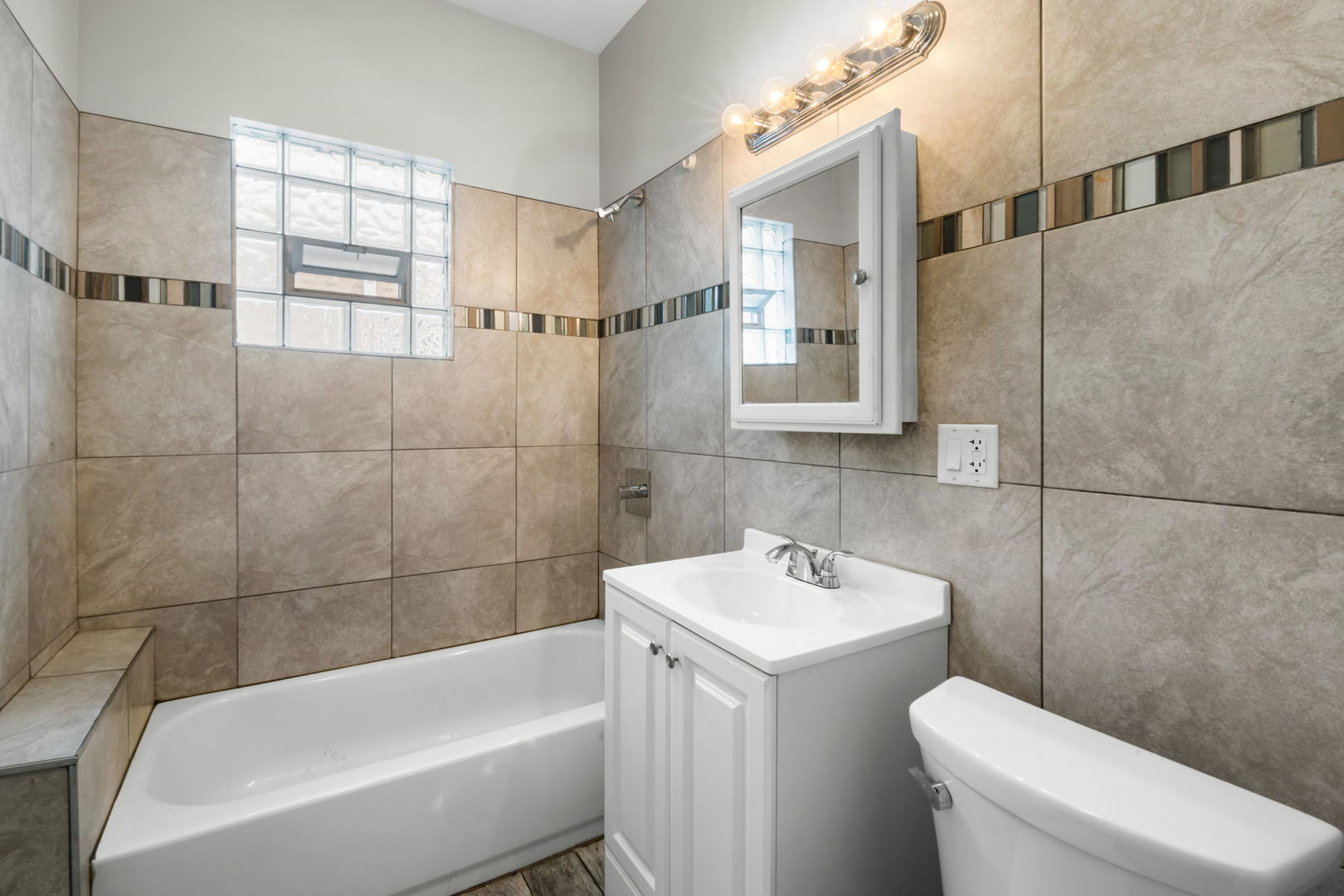 8548 South Exchange Avenue Chicago, IL 60617 - Photo 9 of 32 a bathroom with a sink a toilet and shower
