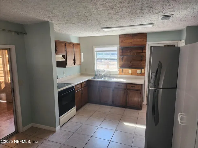 a kitchen with a refrigerator and a sink
