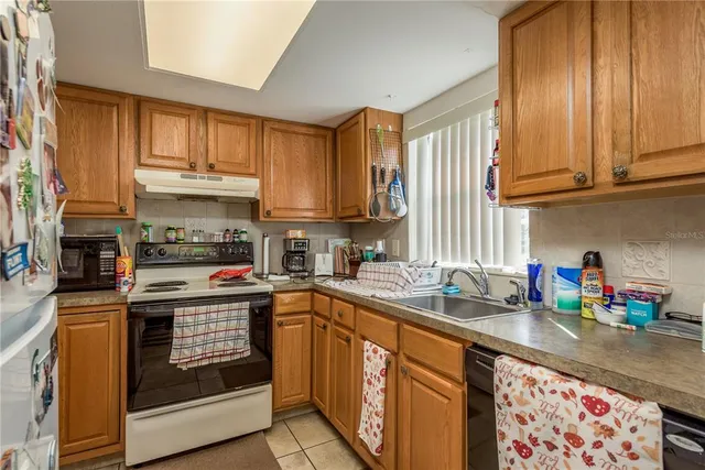 a kitchen with stainless steel appliances granite countertop a sink and cabinets
