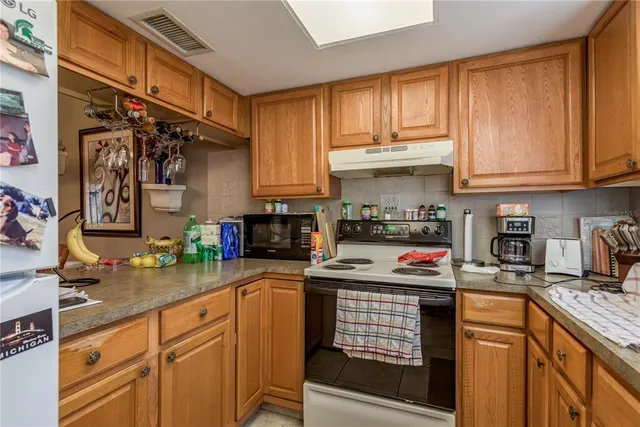 a kitchen with stainless steel appliances a sink and cabinets