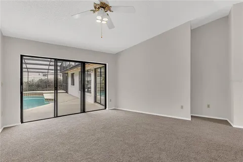 a view of room with window and ceiling fan