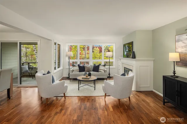 a living room with fireplace furniture and a wooden floor