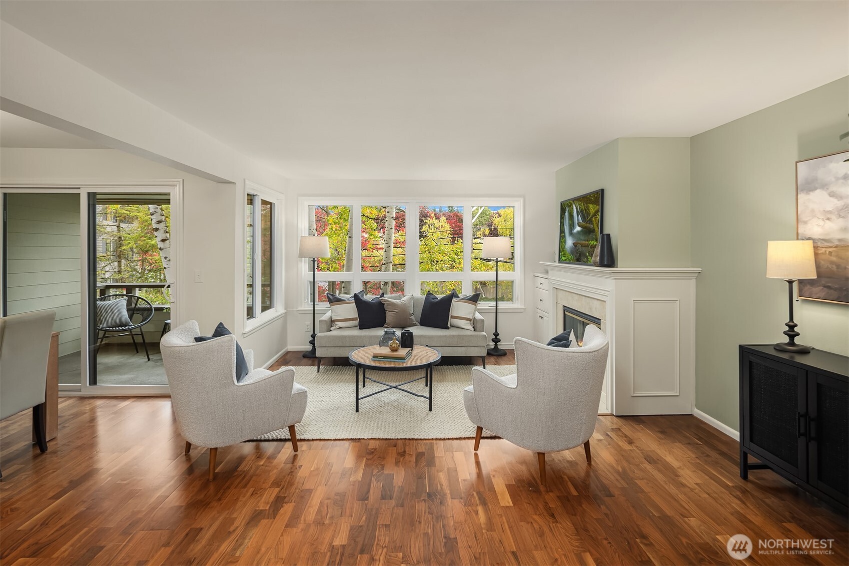 a living room with fireplace furniture and a wooden floor