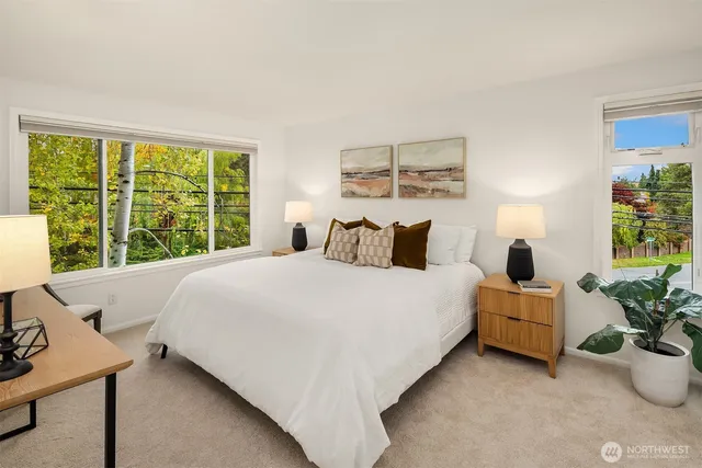 a bedroom with a bed and a large window