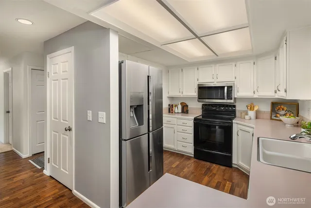 a kitchen with cabinets and stainless steel appliances