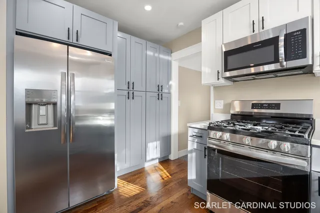 a kitchen with stainless steel appliances granite countertop a stove a refrigerator and a microwave