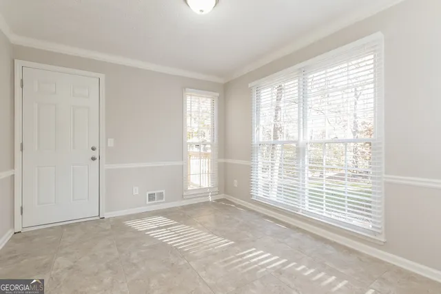 a view of an empty room with a window