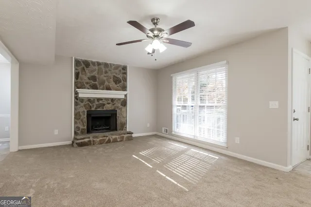 a view of an empty room with a fireplace