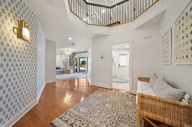 a view of a hallway with wooden floor and closet