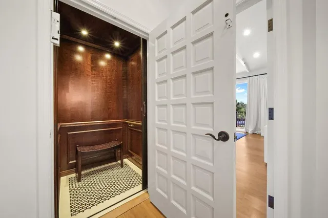 a bedroom with a large bed and a chandelier