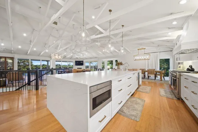 a large bathroom with a granite countertop double vanity sink a bathtub and shower