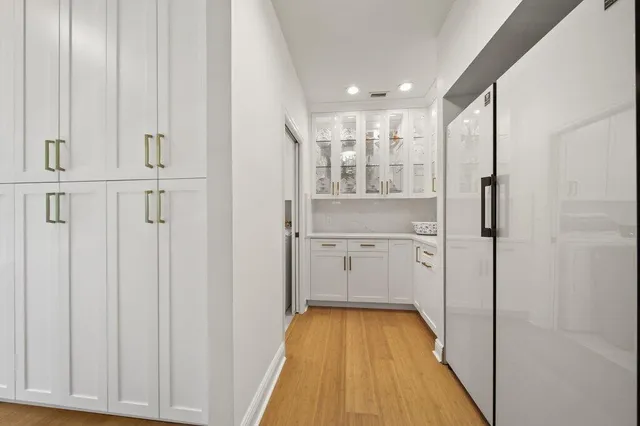 a view of a swimming pool with lawn chairs under an umbrella