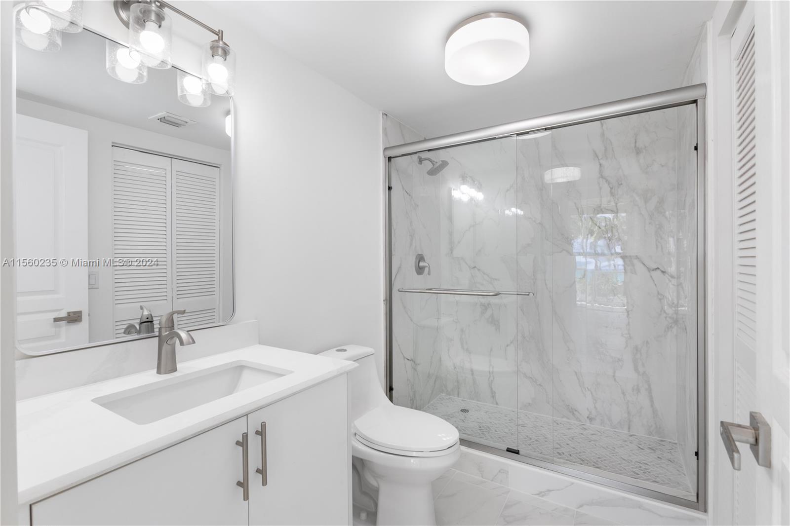 8925 Collins Avenue, Unit 2J Surfside, FL 33154 - Photo 16 of 62 a bathroom with a sink toilet and shower