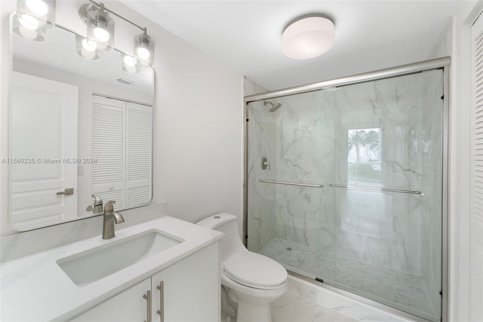 8925 Collins Avenue, Unit 2J Surfside, FL 33154 - Photo 17 of 62 a bathroom with a sink toilet and shower