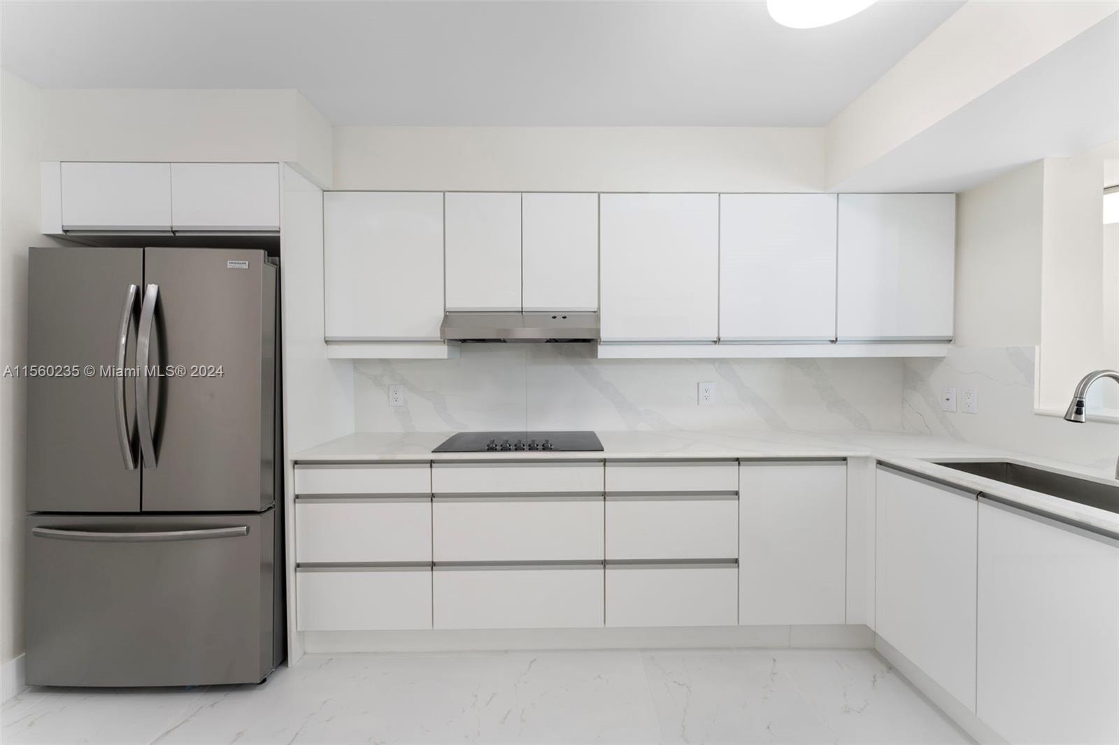 8925 Collins Avenue, Unit 2J Surfside, FL 33154 - Photo 18 of 62 a kitchen with appliances cabinets and a counter top space