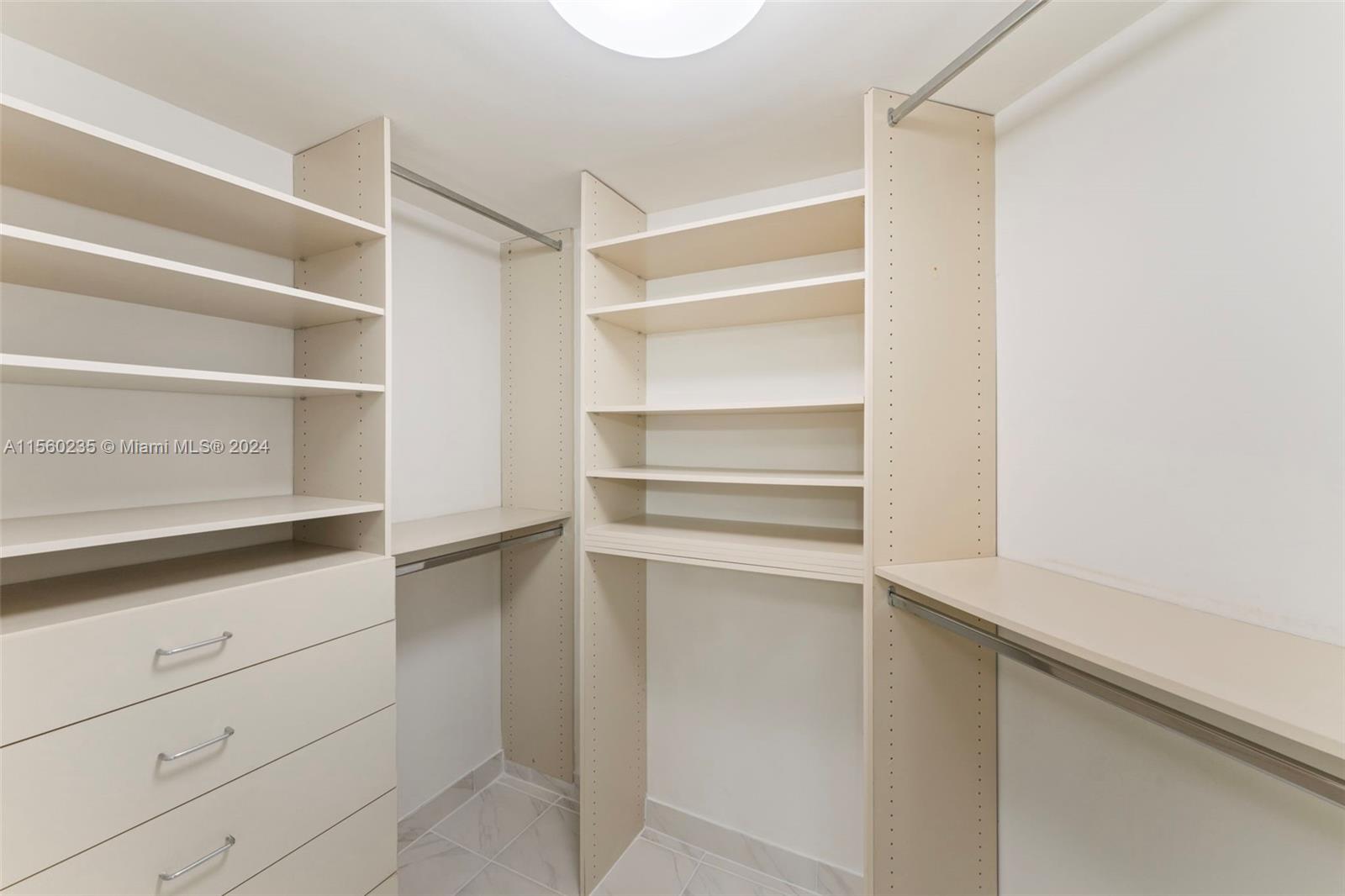 8925 Collins Avenue, Unit 2J Surfside, FL 33154 - Photo 20 of 62 a view of walk in closet with empty racks