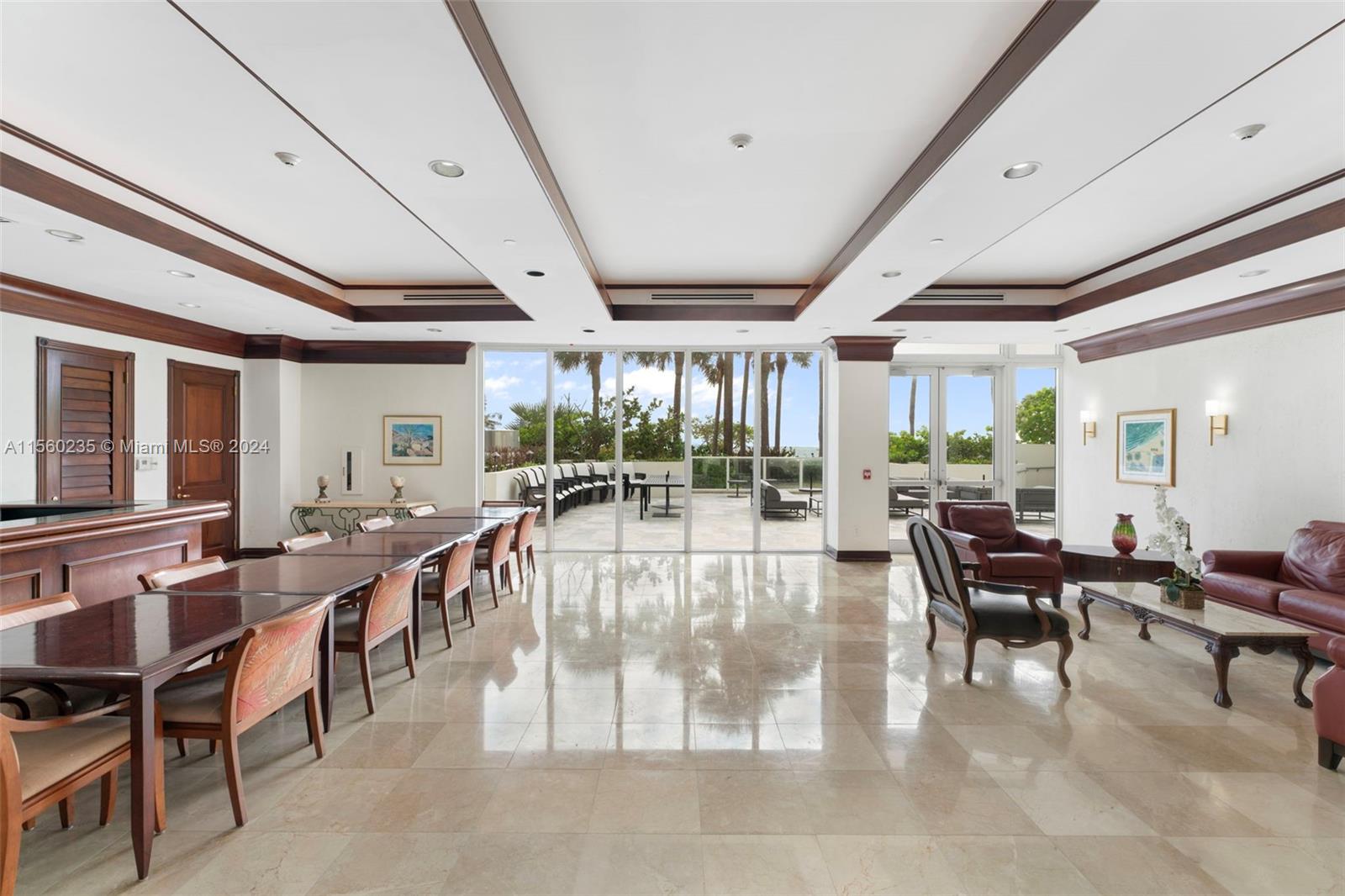 8925 Collins Avenue, Unit 2J Surfside, FL 33154 - Photo 24 of 62 a outdoor space with lots of tables a large window and furniture