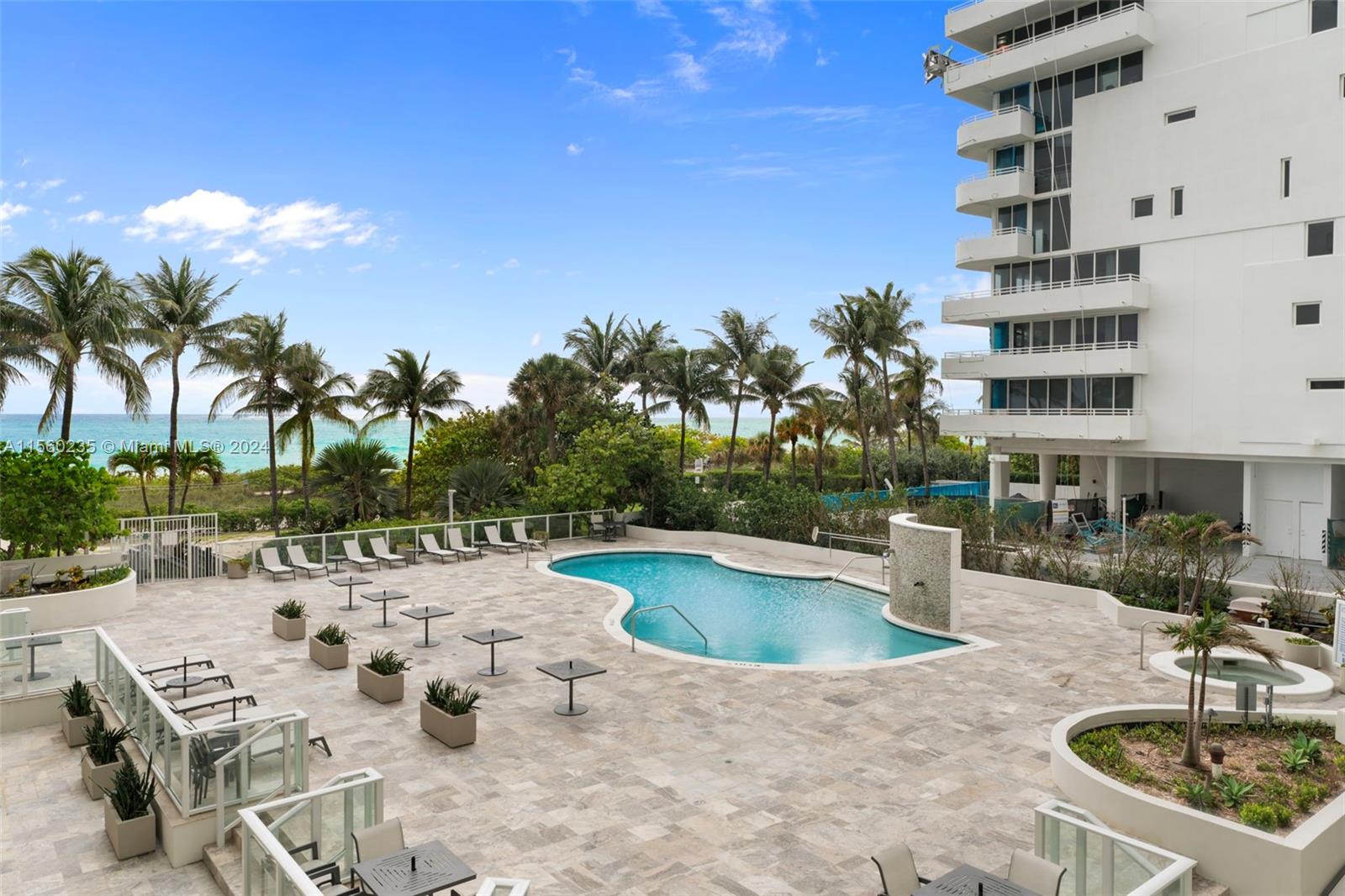 8925 Collins Avenue, Unit 2J Surfside, FL 33154 - Photo 27 of 62 a view of a swimming pool with outdoor seating