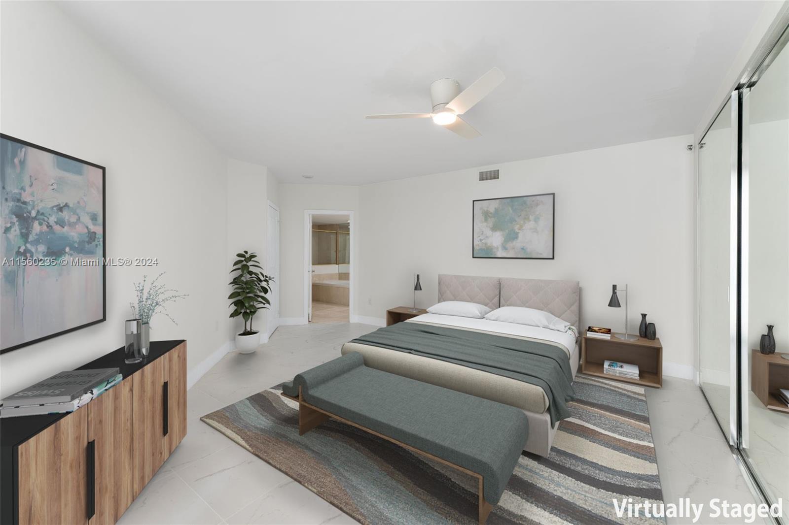 8925 Collins Avenue, Unit 2J Surfside, FL 33154 - Photo 4 of 62 a bedroom with a large bed and a couch