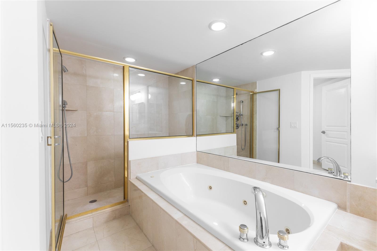 8925 Collins Avenue, Unit 2J Surfside, FL 33154 - Photo 49 of 62 a bathroom with a tub and a shower