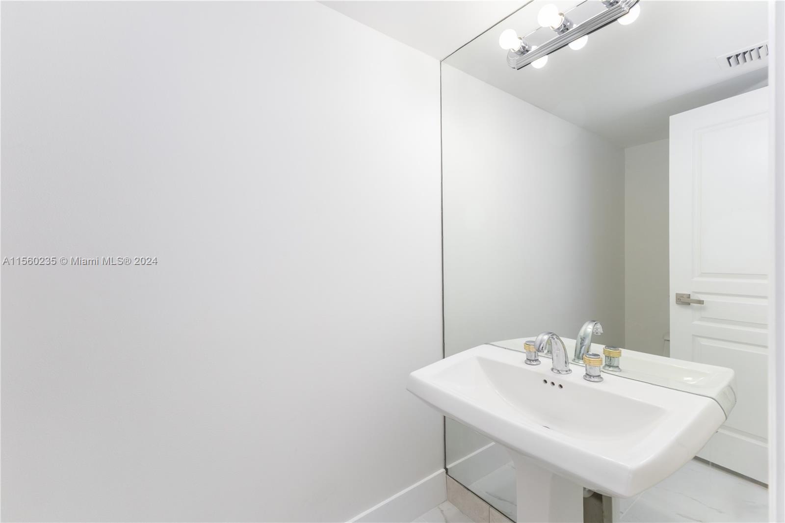8925 Collins Avenue, Unit 2J Surfside, FL 33154 - Photo 50 of 62 a white sink under a bathroom