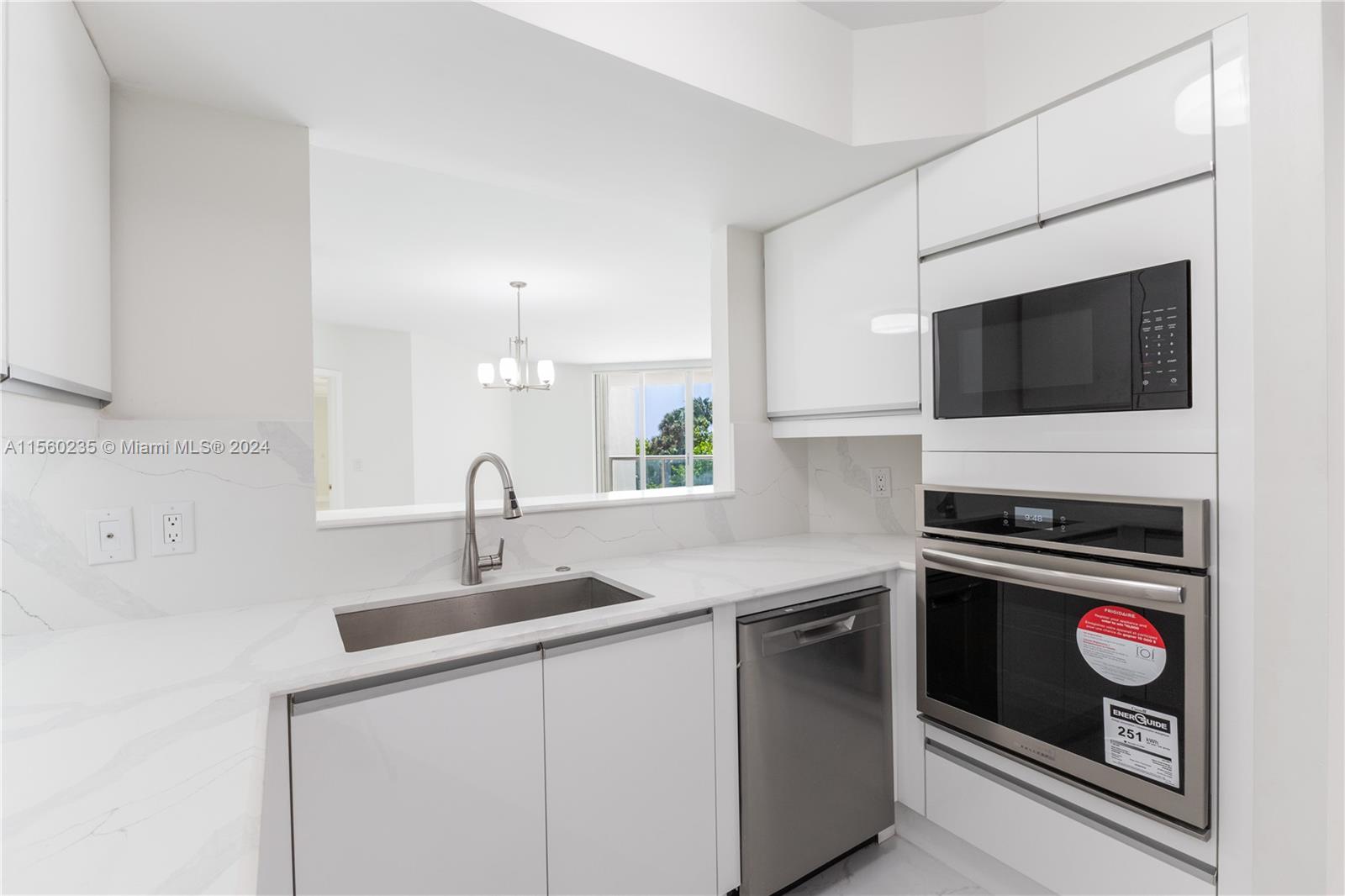 8925 Collins Avenue, Unit 2J Surfside, FL 33154 - Photo 52 of 62 a kitchen with a sink stove and microwave
