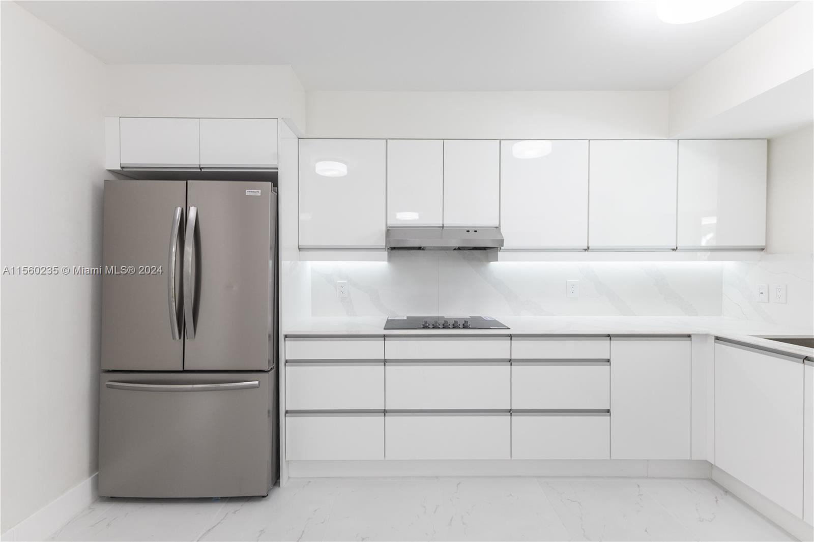 8925 Collins Avenue, Unit 2J Surfside, FL 33154 - Photo 54 of 62 a view of kitchen with refrigerator cabinets and wooden floor
